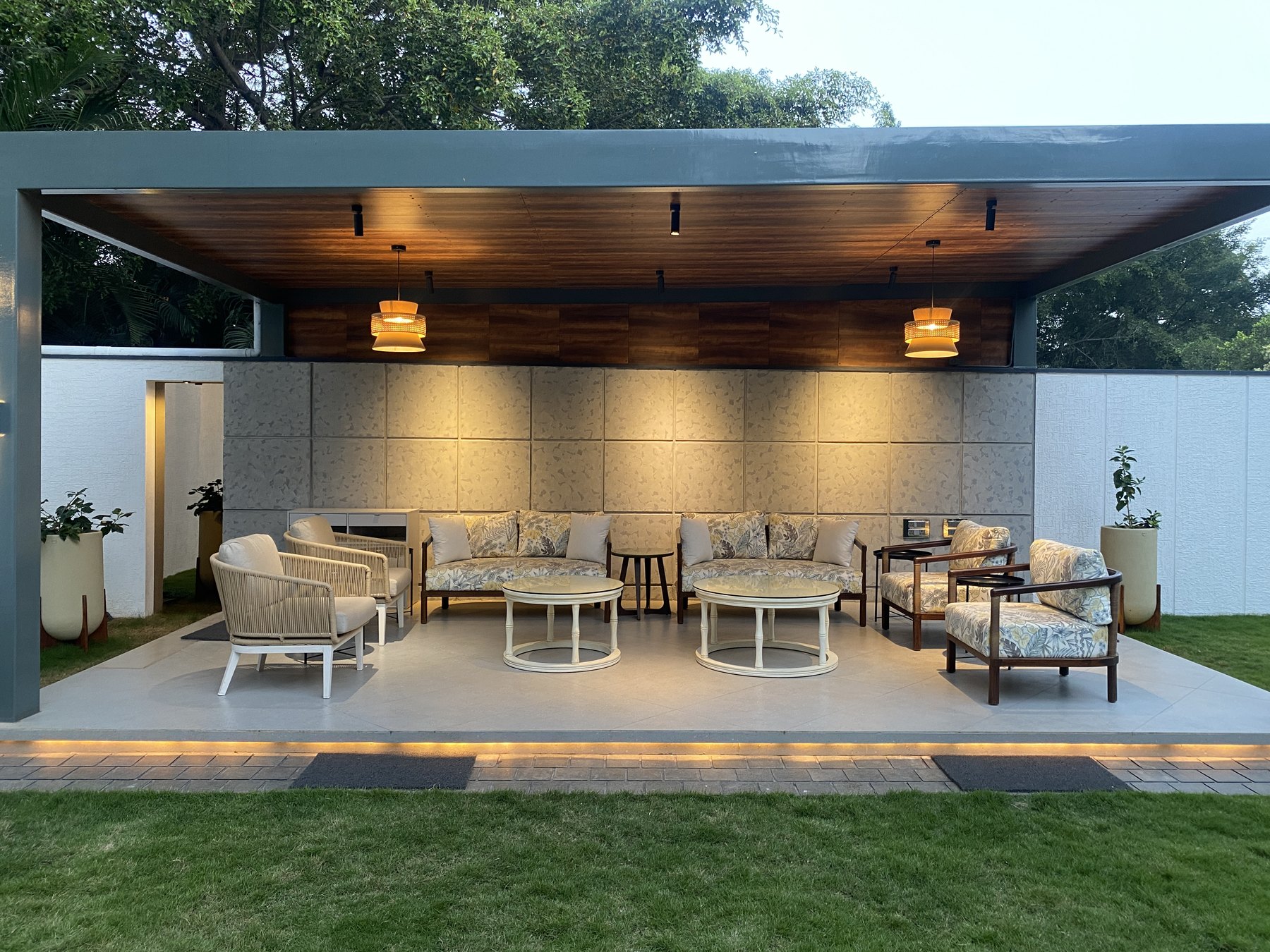 Covered outdoor garden lounge at dusk