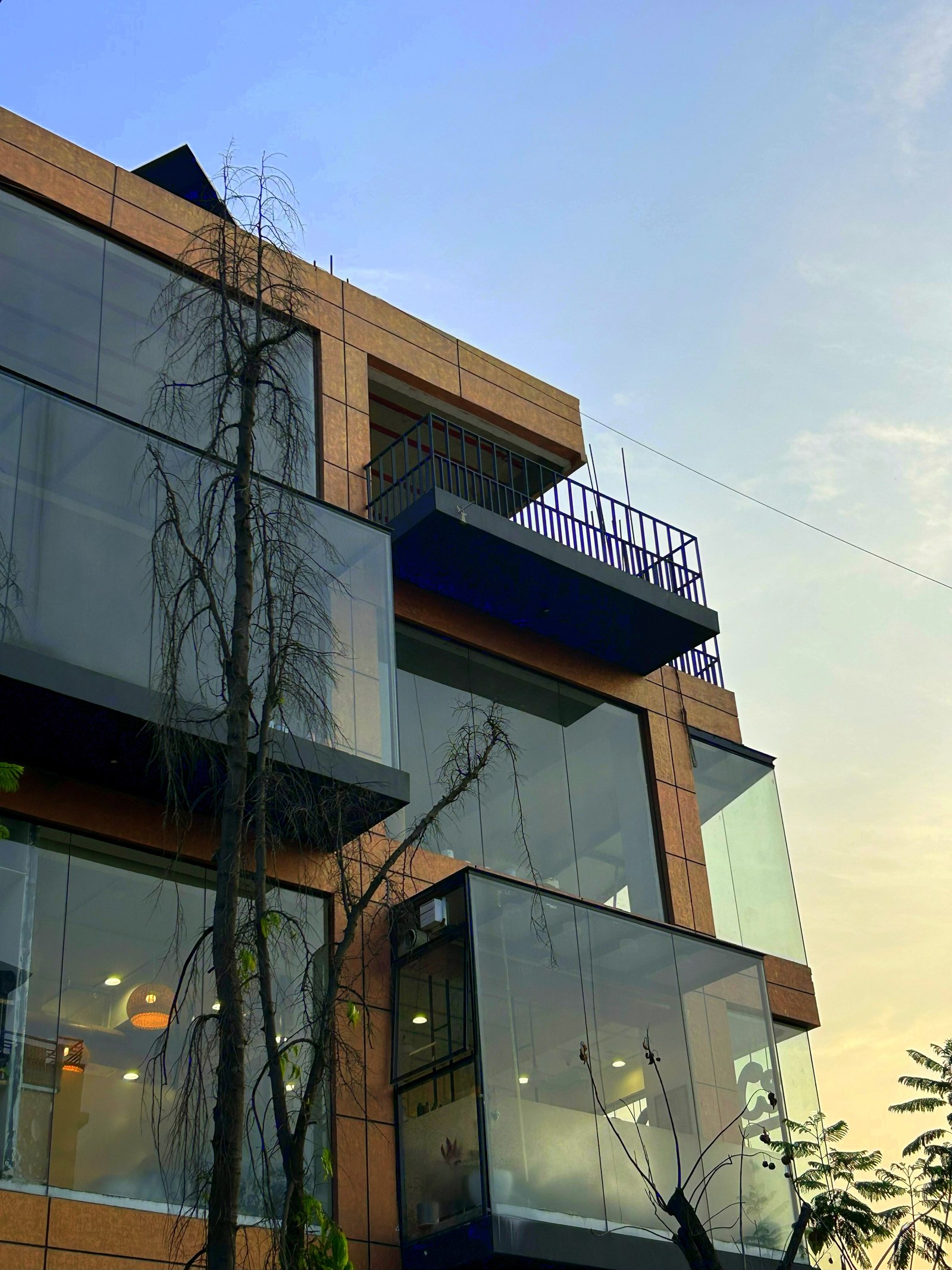 KMU Mixed Commercial — completed building, upward view of glazed retail frontage