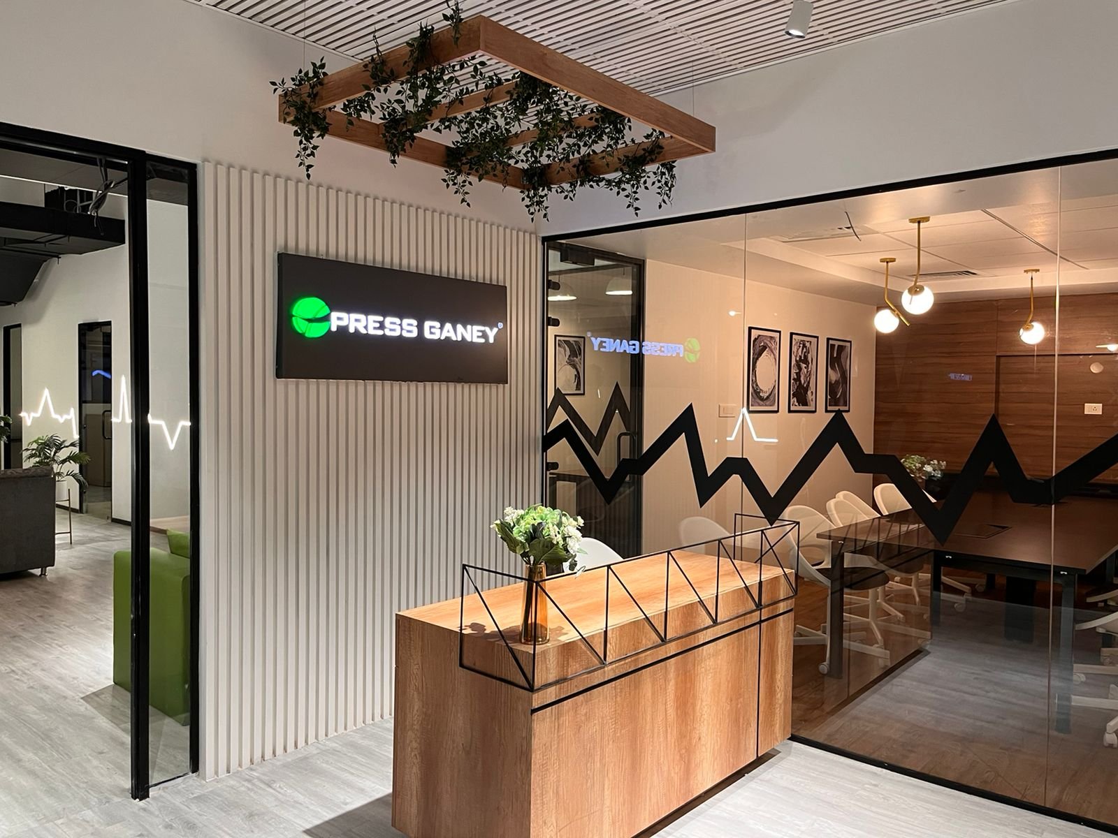 Press Ganey — branded reception with hanging greenery