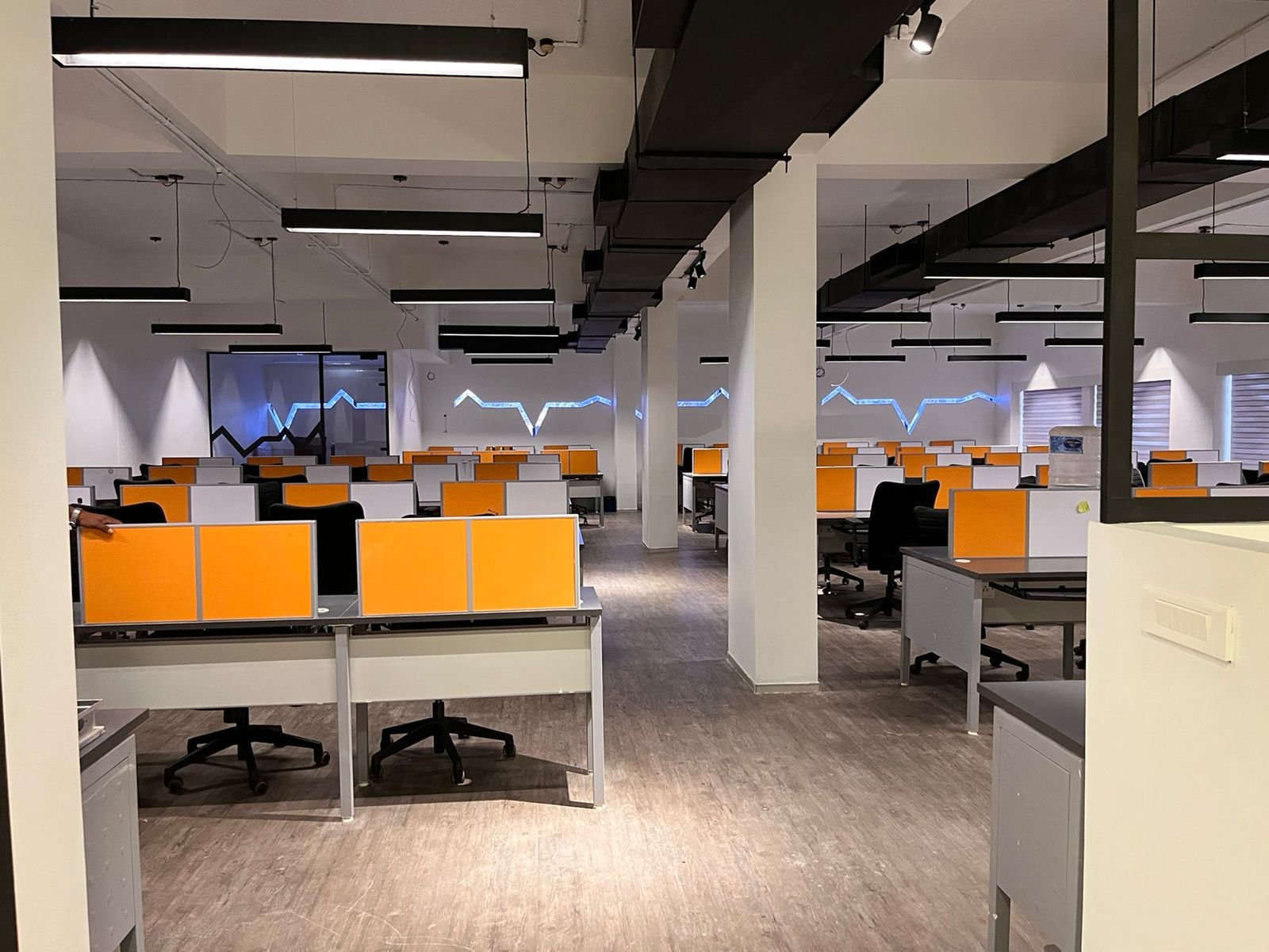 Press Ganey — open workspace floor with heartbeat light line
