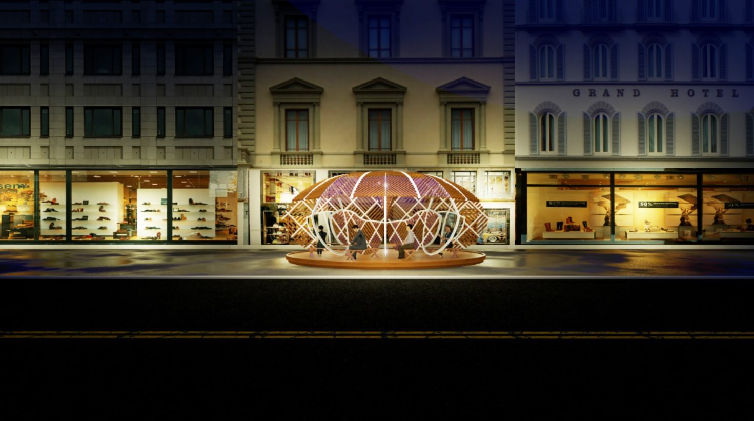 The pod lit at night on a European-style high street
