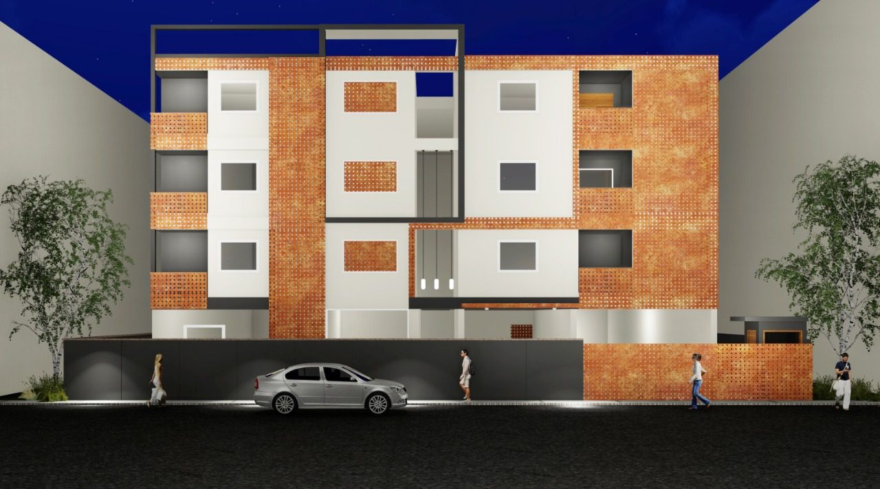K-Apartments — perforated terracotta screen façade illuminated at night