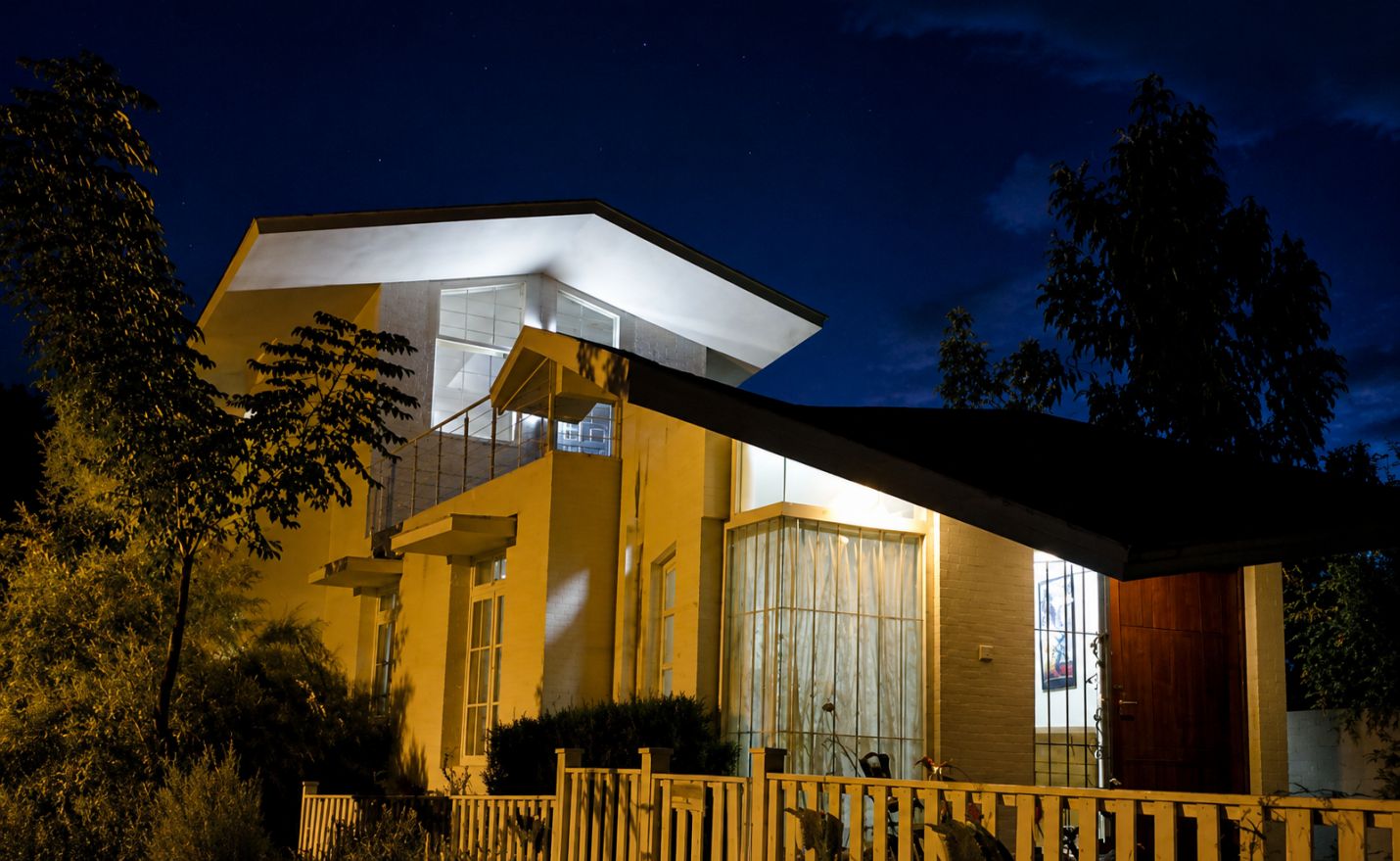 Cedar House — dusk exterior showing the inclined roof planes