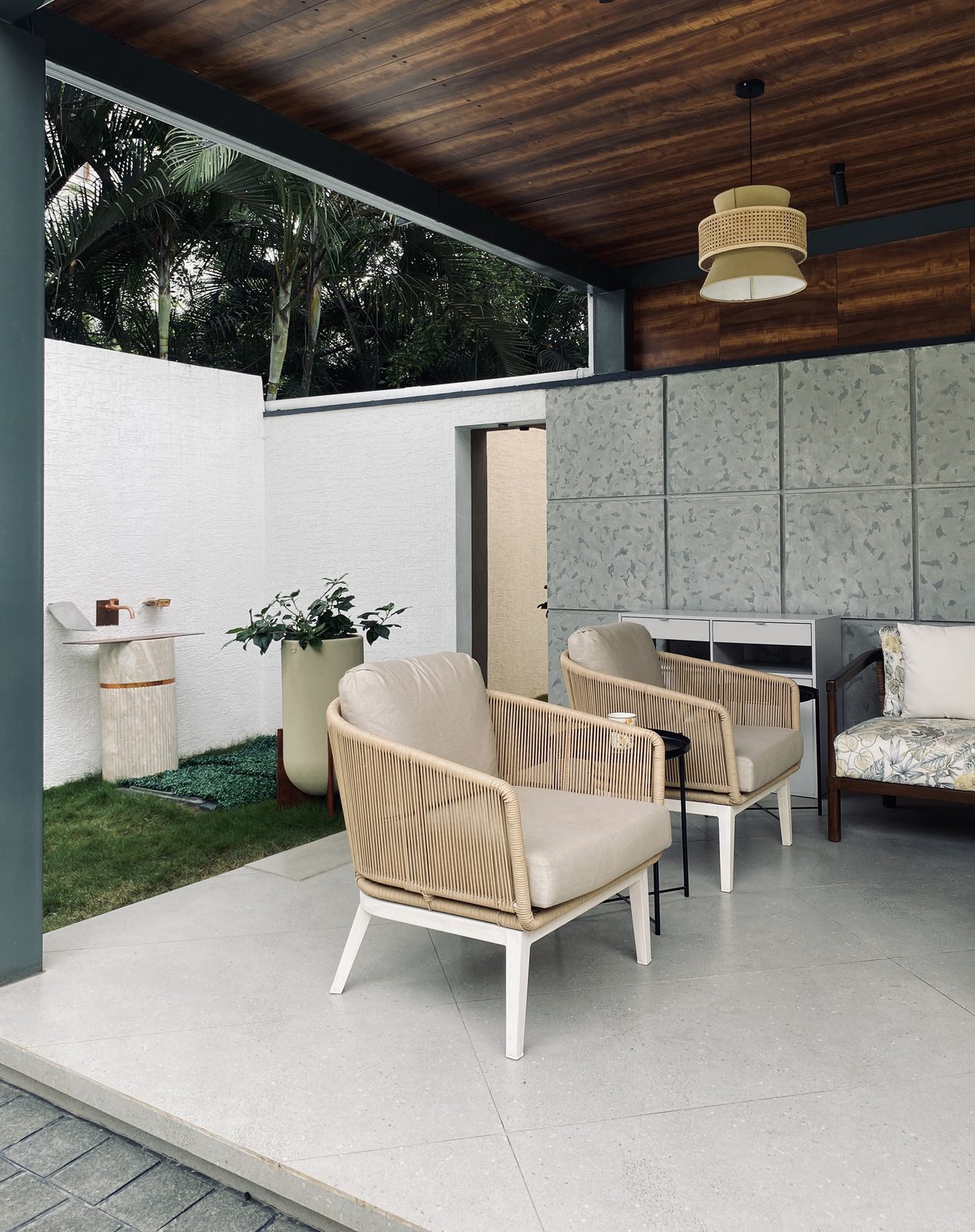 Bafna residence — covered patio with terrazzo cladding, timber soffit and stone basin