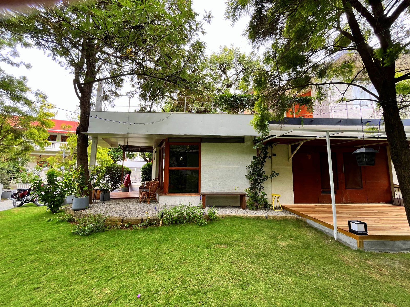 TA House — garden view with elevated terrace and cantilevered roof