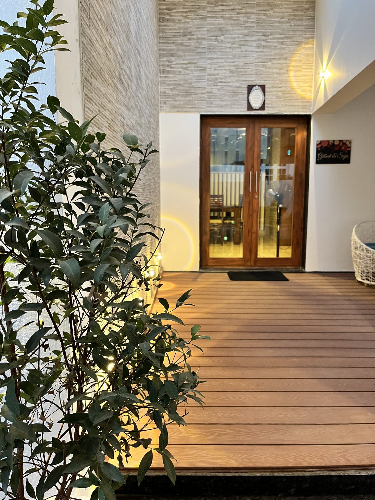 Gilbert — timber-and-glass front door with the Gilbert & Suja nameplate