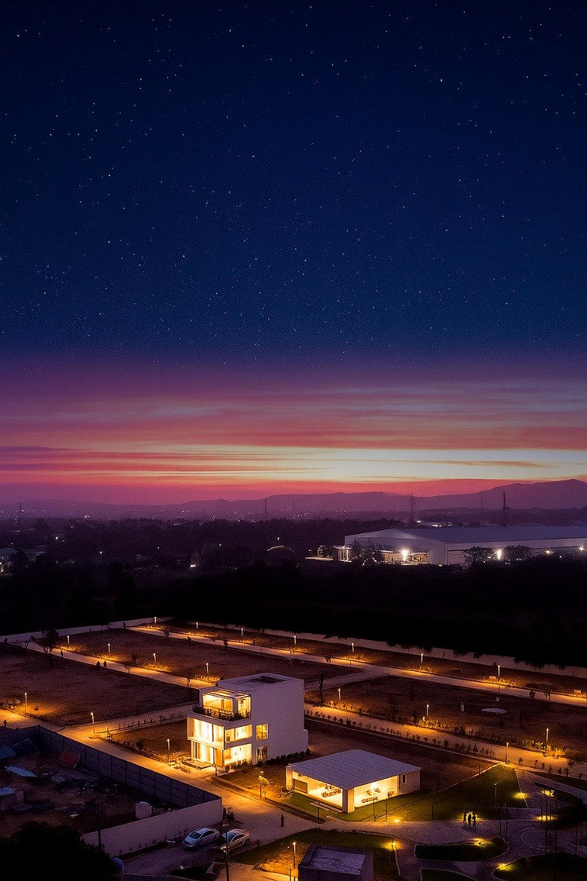 Smart City Bidadi — aerial view of the villa community at dusk with lit streets