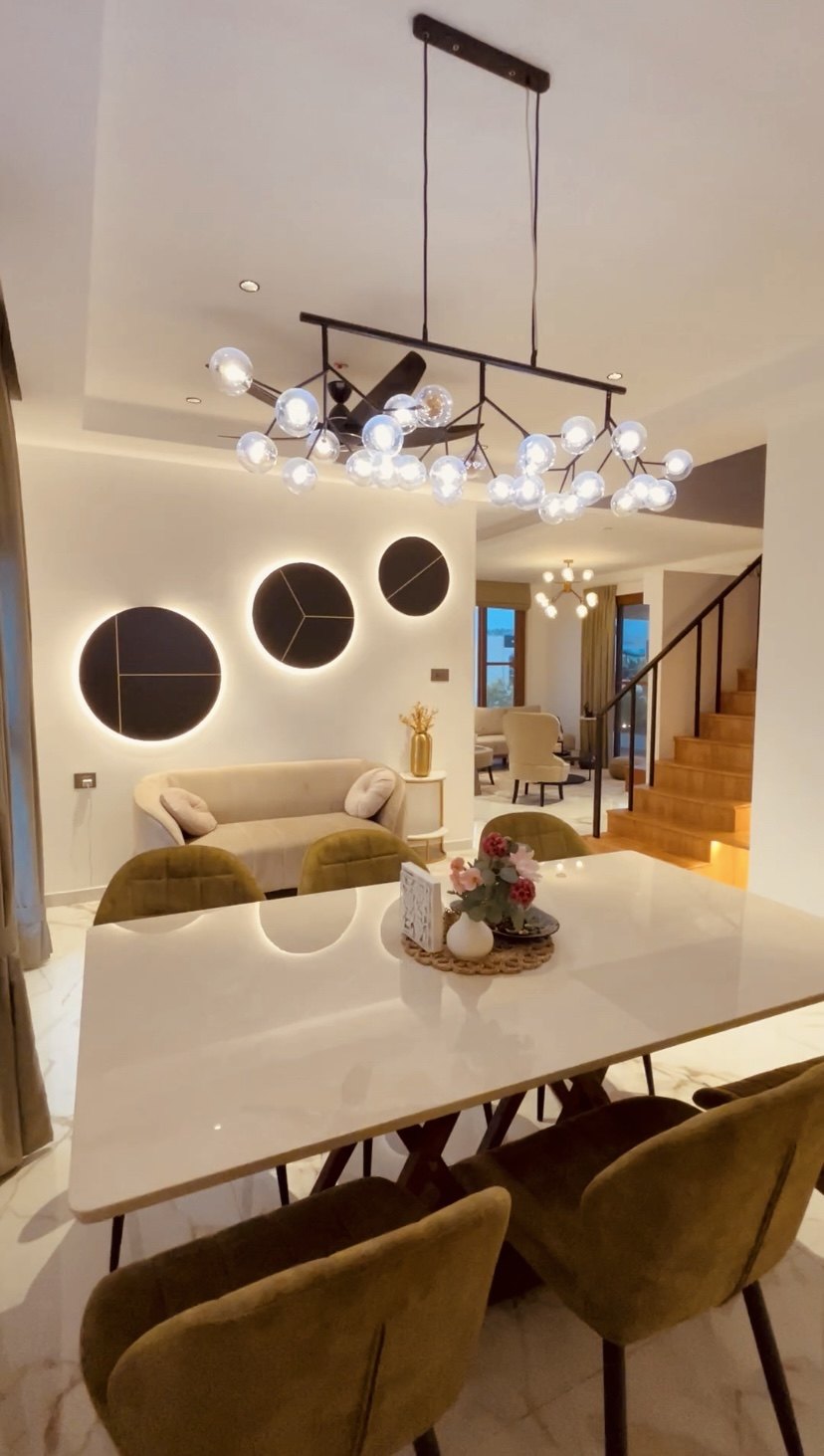 Smart City Bidadi villa — dining area with sculptural lighting